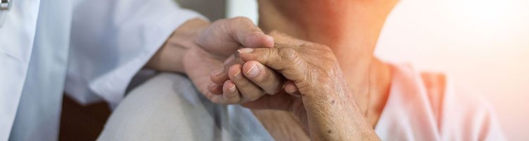 Doctor holding patient's hand